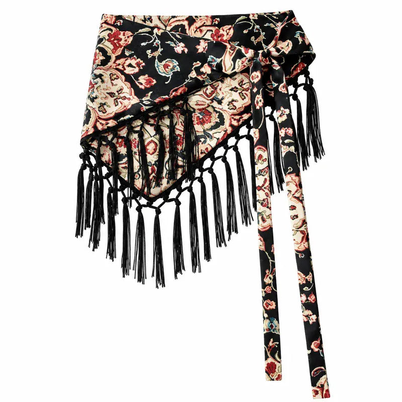 Cinturón pañoleta Bohemia Chic con estampado flora fondo negro, amarre lateral y flecos negros sobre fondo blanco.