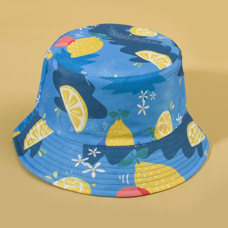 Sombrero Bucket Doble Vista reversible con estampado de limones azules y reverso color negro.