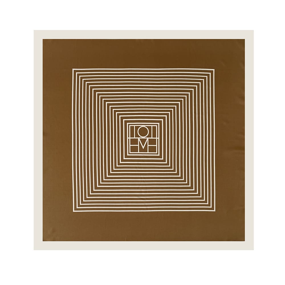 Pañoleta satinada geométrica de 90 × 90 cm en tonos camel y marfil mostrando el diseño completo de líneas.